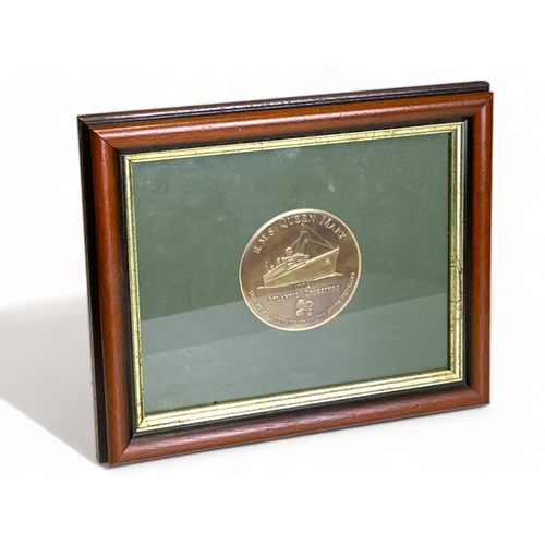 649 - Framed bronze plaque commemorating the RMS Queen Mary and her 1002 Atlantic crossings, made from the... 