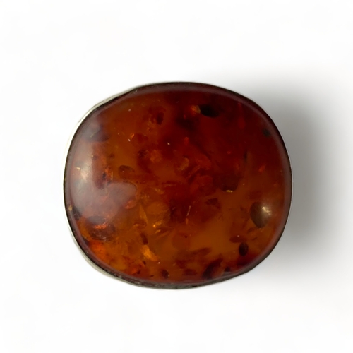 501 - A Silver and Baltic amber oval brooch, 4.1cm by 3.7cm. Unmarked but tested.