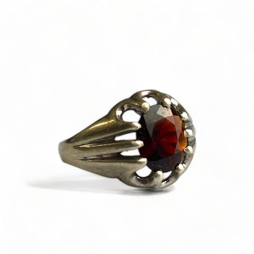 641 - A Sterling silver and solitaire claw set garnet ring, Birmingham 1977, size O.