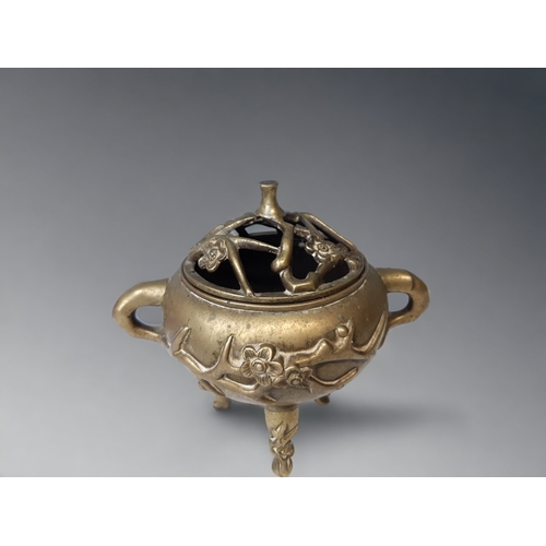 27 - A CHINESE BRONZE TRIPOD CENSER. 
LATE QING DYNASTY. RELIEF DECORATED WITH PRUNUS BLOSSOM. MARKED TO ... 