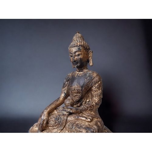 28 - A 19TH CENTURY TIBETAN GILT BRONZE SHAKYAMUNI BUDDHA. ROBES ADORNED WITH SCROLLING DRAGONS.
HEIGHT -... 