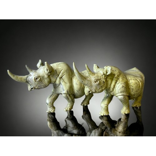 701 - A large pair of Zimbabwean (Shona) people Butterjade Rhinoceros carved sculptures. 
15 x 30cm