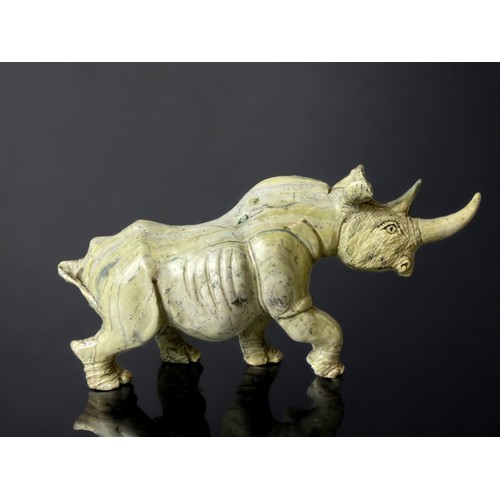 701 - A large pair of Zimbabwean (Shona) people Butterjade Rhinoceros carved sculptures. 
15 x 30cm