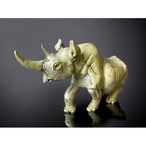 701 - A large pair of Zimbabwean (Shona) people Butterjade Rhinoceros carved sculptures. 
15 x 30cm