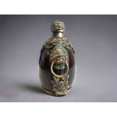 69 - A Chinese polished Nut, metal mounted large snuff bottle. 
Marks to base.
Height - 11.5 cm