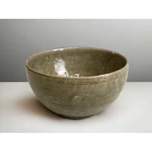 67 - A Chinese Celadon glaze 'Shipwreck' bowl.
Ming dynasty. Incised decoration.
7 x 13 cm