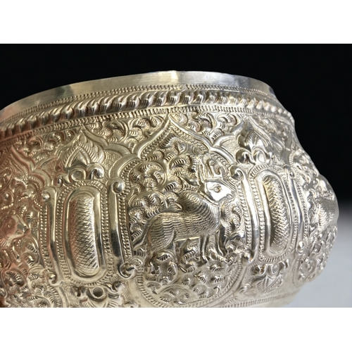 765 - A Burmese Silver 'Thabeik' bowl.
Ornately embellished with chased repoussé series of animals. Inscri... 