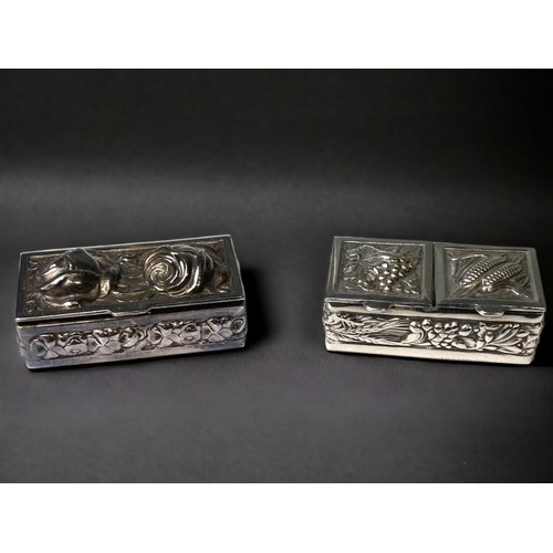 731 - 925 silver snuff or pill boxes in a coffer shape one with twin rose repousse shape lid the second ha... 