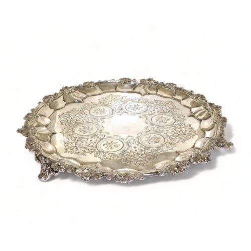 751 - Silver H/M 3 leg salver with embossed decoration standing on scrolled feet 23cm diameter 333g