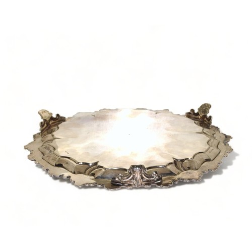 751 - Silver H/M 3 leg salver with embossed decoration standing on scrolled feet 23cm diameter 333g