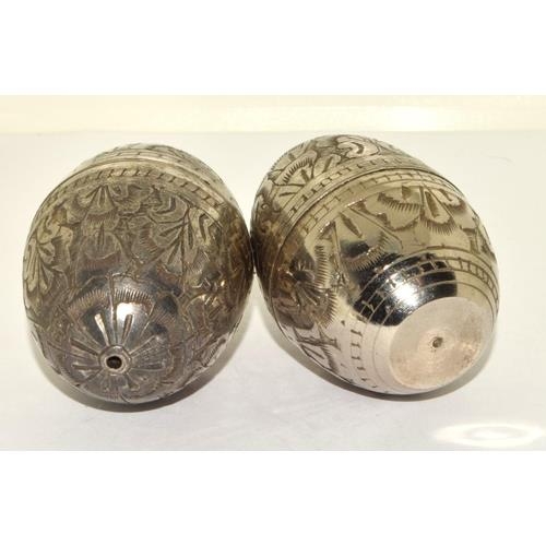 739 - PAIR OF INDIAN WHITE METAL 'EGG'  SALT & PEPPER SHAKERS. ENGRAVED IN A FOLIATE DESIGN.
HEIGHT - 6CM