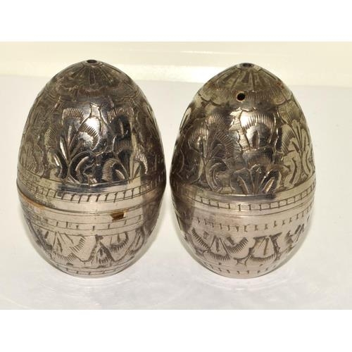 739 - PAIR OF INDIAN WHITE METAL 'EGG'  SALT & PEPPER SHAKERS. ENGRAVED IN A FOLIATE DESIGN.
HEIGHT - 6CM