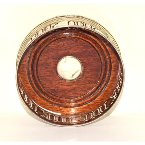 741 - A STERLING SILVER & MAHOGANY '2000' WINE COASTER. HALLMARKED. 
4.5 X 12CM