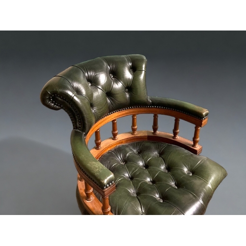 773 - A green leather Chesterfield Captains swivel chair.