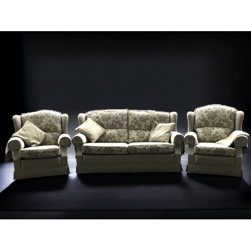 111 - A VINTAGE FOUR-PIECE UPHOLSTERED SOFA, TWO ARMCHAIRS AND OTTOMAN. FOLIATE DESIGN.