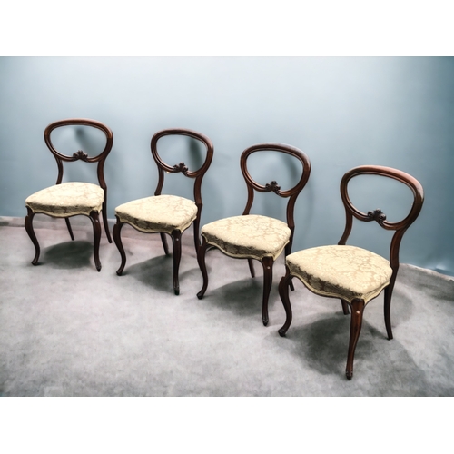 113 - SET OF FOUR VICTORIAN WALNUT BALLOON BACK DINING CHAIRS. ORNATELY CARVED WITH FLEUR-DE-LIS STYLE DES... 