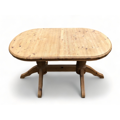 127 - A TWIN PEDESTAL PINE DINING TABLE.