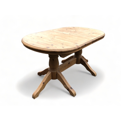 127 - A TWIN PEDESTAL PINE DINING TABLE.