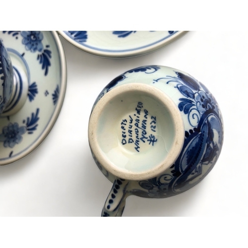 208 - A COLLECTION OF SIX VINTAGE HAND PAINTED DELFT BLUE & WHITE TEACUPS & SAUCERS.