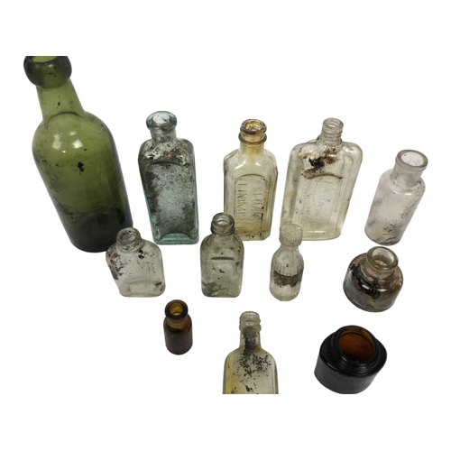 232 - A mixed collection of antique glass bottles.