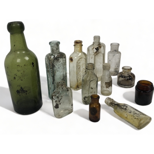 232 - A mixed collection of antique glass bottles.