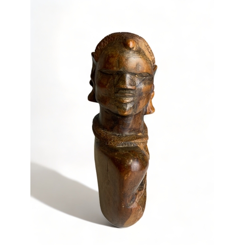 253 - A HEAVY AFRICAN HARD WOOD HAND CARVED STATUE