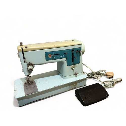 296 - A VINTAGE SINGER ELECTRIC SEWING MACHINE WITH INSTRUCTIONS AND PEDAL ETC