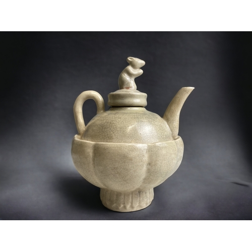 101 - A CHINESE GE-TYPE TEAPOT. WITH RAT KNOP. CREAM CRACKLE GROUND.
HEIGHT - 17CM