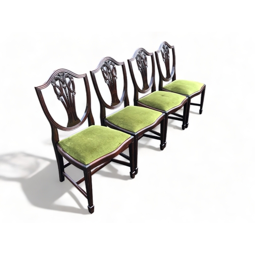 335 - A set of four Mahogany Chippendale style dining chairs. With carved stylised fleur-de-lis back.