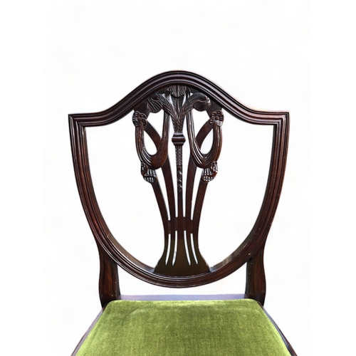 335 - A set of four Mahogany Chippendale style dining chairs. With carved stylised fleur-de-lis back.