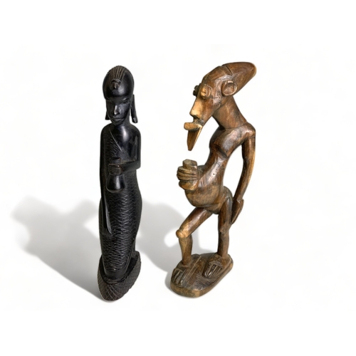 358 - 3 East African carved female seated figures, together with another.