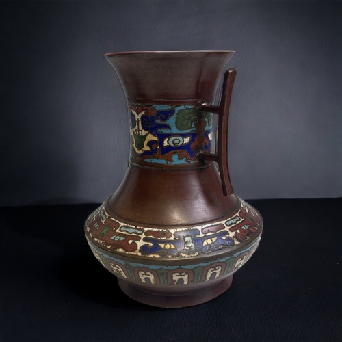 362 - A JAPANESE BRONZE ENAMEL CHAMPLEVE VASE. 
MEIJI PERIOD.
TWIN HANDLED ARCHAISTIC STYLE DESIGN.
HEIGHT... 