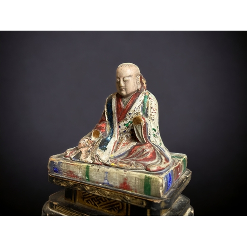 90 - A CHINESE CARVED WOOD POLYCHROME FIGURE OF BUDDHISTIC MONK. 
QING DYNASTY. 
ON BLACK & GILT BASE. WI... 