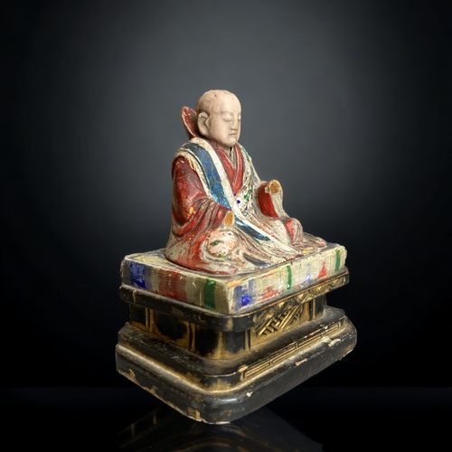 90 - A CHINESE CARVED WOOD POLYCHROME FIGURE OF BUDDHISTIC MONK. 
QING DYNASTY. 
ON BLACK & GILT BASE. WI... 