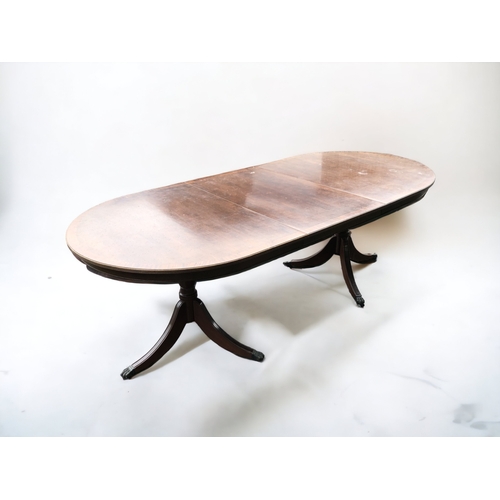 368 - A MAHOGANY EXTENDING TRIPOD DINING TABLE. CENTRAL LEAF. METAL LION PAW CASTERS.