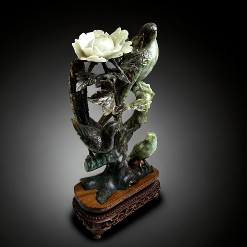 174 - A collection of Chinese carved jade & hardstone sculptures. Including a bird & flower group on carve... 