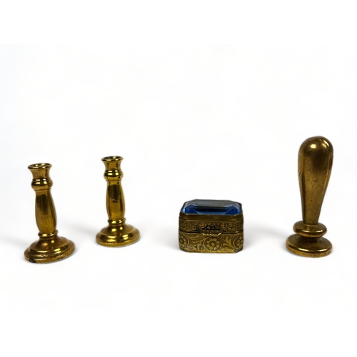 39 - A miscellaneous collection of brass. Including dolls house candlesticks, engraved pill box, un-engra... 