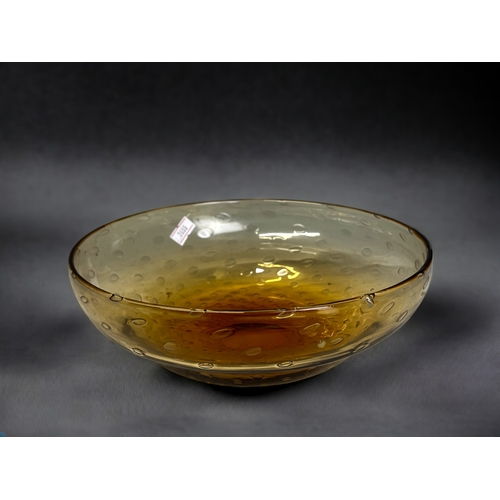 138 - A Whitefriars Amber 'Controlled bubble' glass bowl. 
7.5 x 22cm