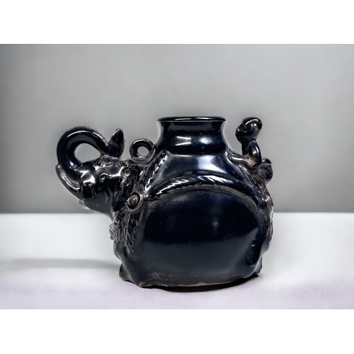 167 - A CHINESE BLACK GLAZE JIZHOU TYPE WATER DROPPER.
Bulbous form 'Elephant' with rider. 
10 x 14.5 cm