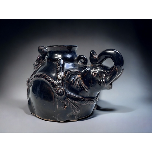 167 - A CHINESE BLACK GLAZE JIZHOU TYPE WATER DROPPER.
Bulbous form 'Elephant' with rider. 
10 x 14.5 cm