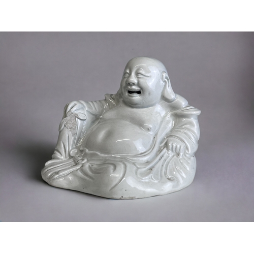 182 - A CHINESE PORCELAIN SEATED BUDDHA.
Qing dynasty.