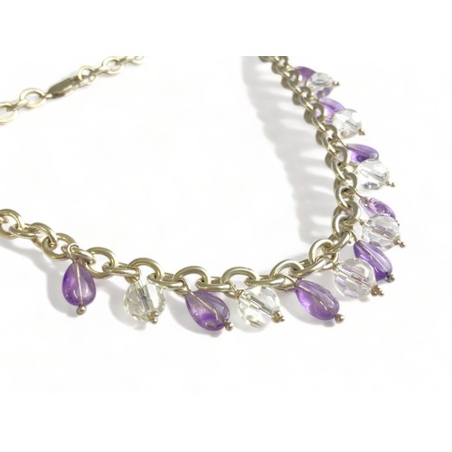 85 - A LADIES STERLING SILVER NECKLACE. SET WITH PURPLE & CLEAR CRYSTAL DROPS.  GROSS WEIGHT - 70.7G