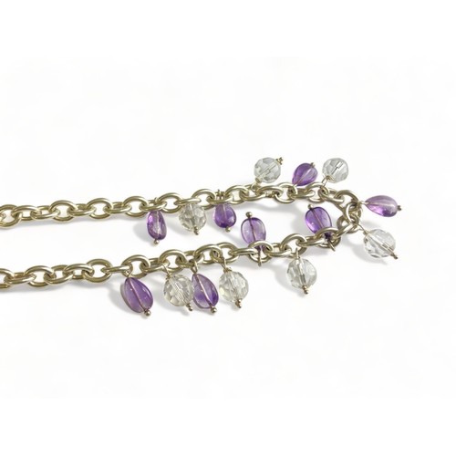 85 - A LADIES STERLING SILVER NECKLACE. SET WITH PURPLE & CLEAR CRYSTAL DROPS.  GROSS WEIGHT - 70.7G