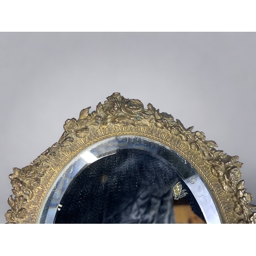 65 - ANTIQUE GILT METAL TABLE MIRROR.
Floral decorated border, with bevel edged mirror.
25.5 x 19.5cm