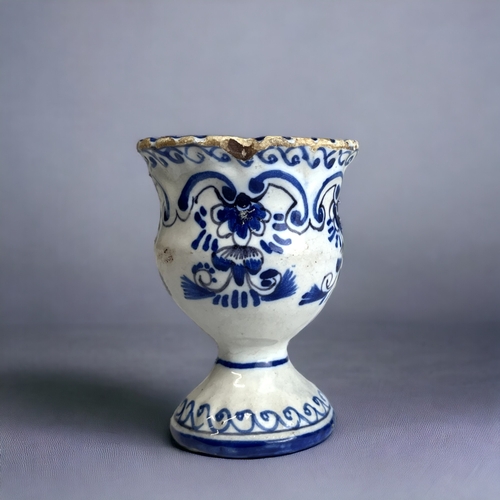 128 - A BLUE & WHITE PAINTED DUTCH DELFT EGG CUP. 18th-Century. moulded form, with painted stylised fo... 