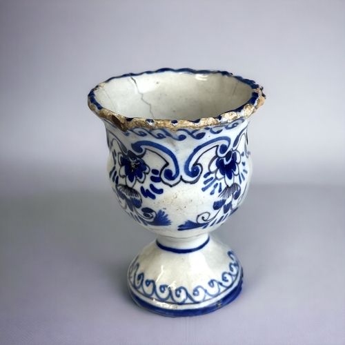 128 - A BLUE & WHITE PAINTED DUTCH DELFT EGG CUP. 18th-Century. moulded form, with painted stylised fo... 