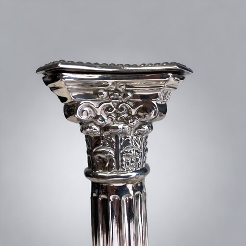 96 - A STERLING SILVER CORINTHIAN CAPITOL COLUMN CANDLESTICK.
Birmingham, 1965 hallmarks. 
Height - 19.5c... 