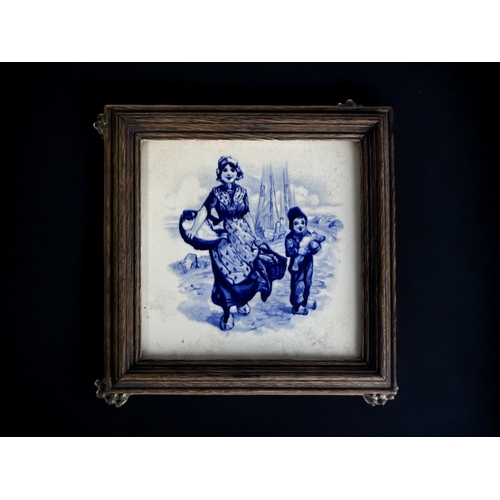 133 - A PAINTED DELFT TILE TRIVET STAND.
19th Century. 
Wood framed, with gilt metal Lion paw feet. 
5 x 2... 