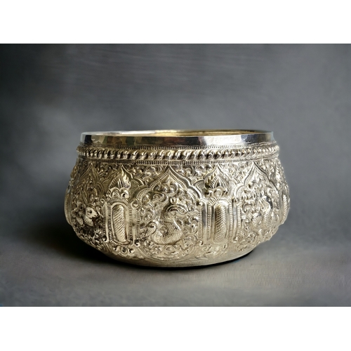 113 - A Burmese Silver 'Thabeik' bowl.
Ornately embellished with chased repoussé series of animals. Inscri... 