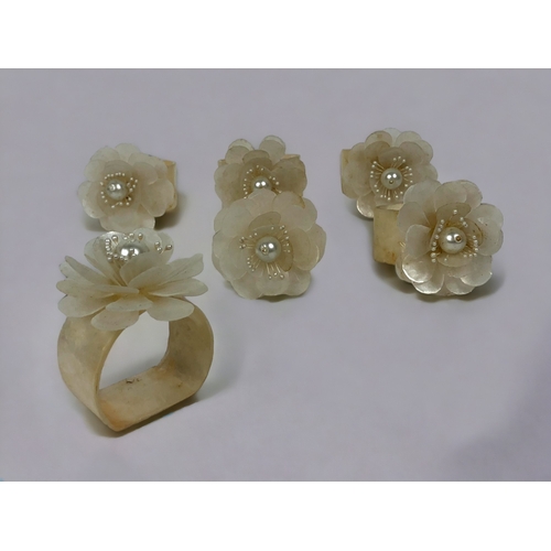 94 - A SET OF SIX MOTHER OF PEARL NAPKIN RINGS.
Floral design.